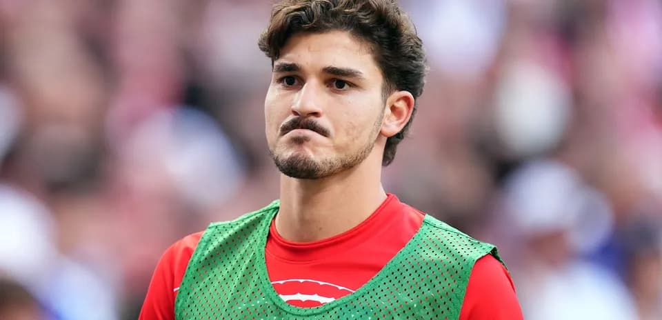 Player in training bib during match warm-up