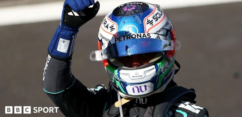 Racing driver celebrating with a raised fist