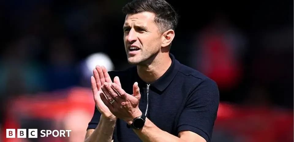 Coach applauding during a match from the sidelines