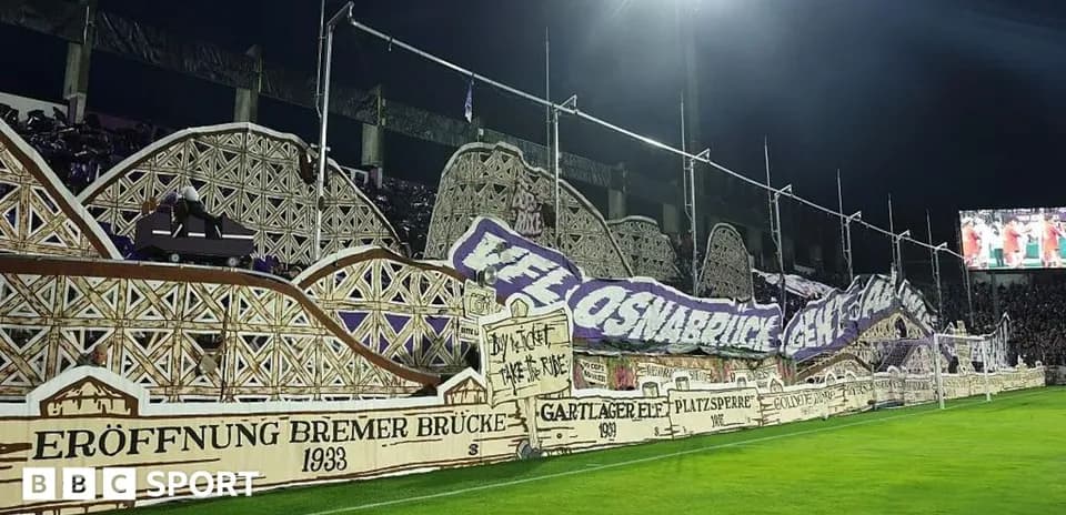 Large fan banner displayed in stadium during match