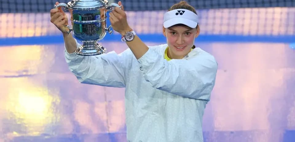 Player holding trophy on tennis court after victory