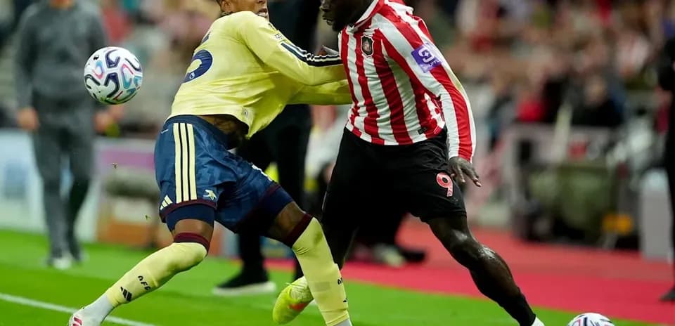 Two players competing for the ball during match action