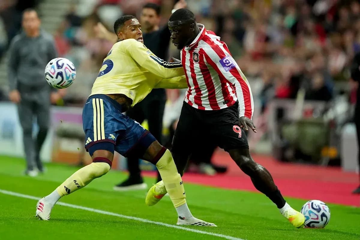 Two players competing for the ball during match action