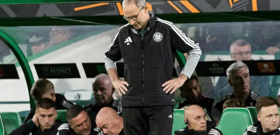 Coach looking down while team sits on bench