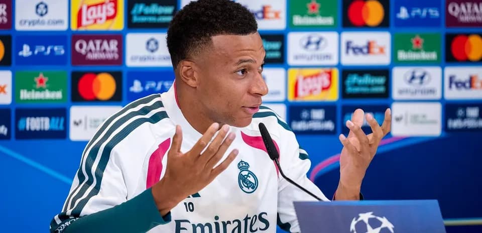 Player speaking at press conference with UEFA backdrop