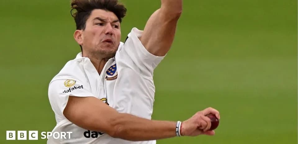 Cricketer bowling during a match action shot