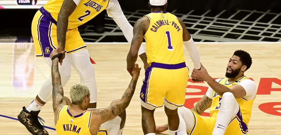 Lakers players helping teammates get up from floor