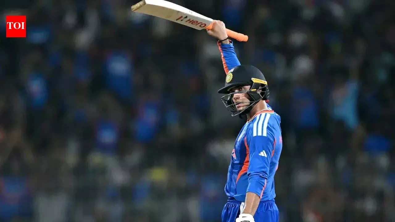 Batsman celebrating with raised bat after scoring runs