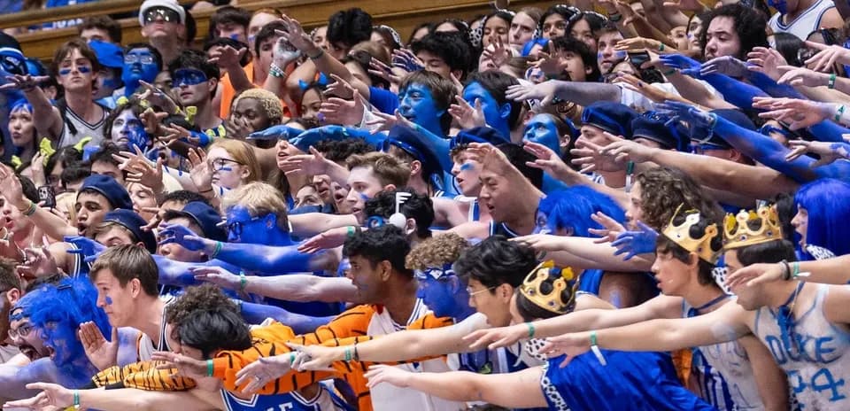 Duke University fans cheering with blue body paint