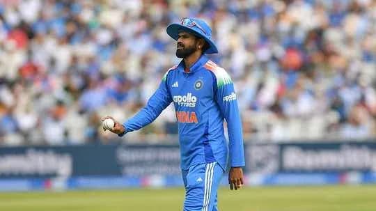 Cricketer in blue uniform holding a ball