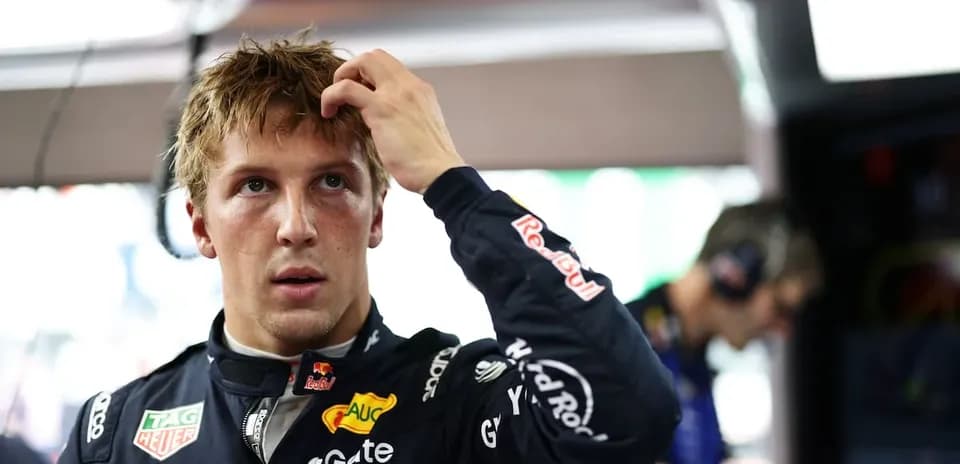 Driver adjusting hair in racing garage before event