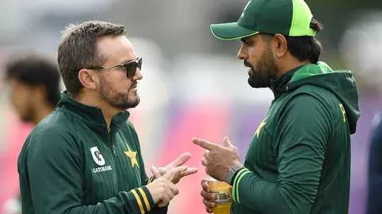 Two coaches discussing strategies during training session