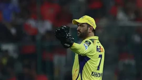 Cricketer in yellow jersey signaling during match
