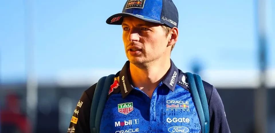 Driver wearing team gear walking towards camera