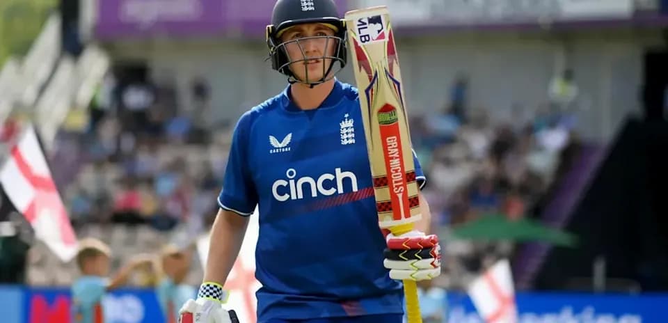 Cricketer walking with bat during match