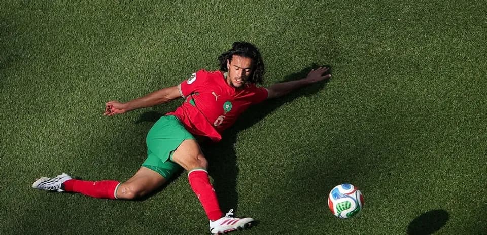 Player on the ground reaching for the ball