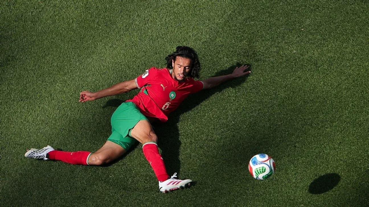 Player on the ground reaching for the ball