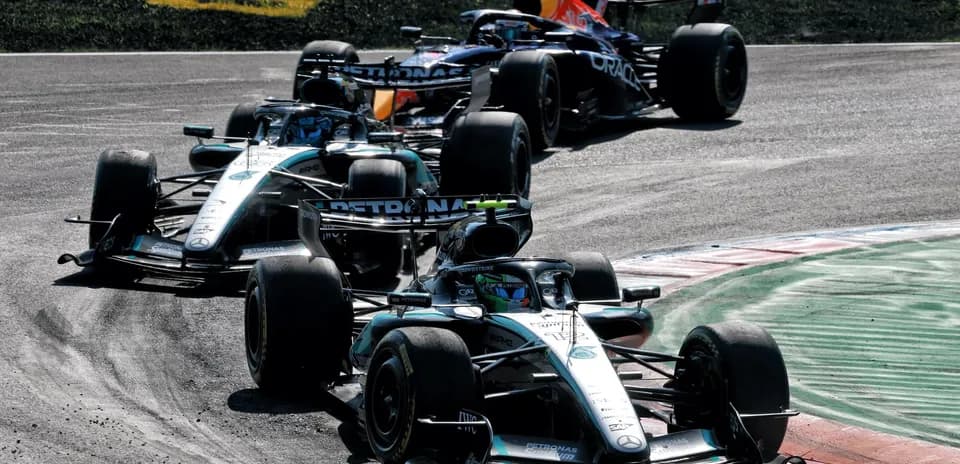 Three Formula 1 cars racing on a track