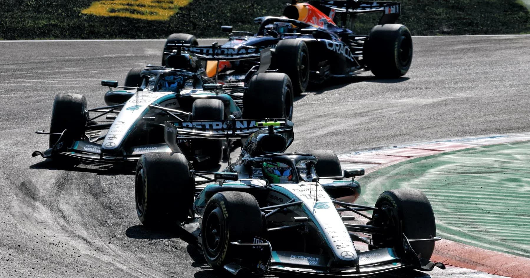 Three Formula 1 cars racing on a track