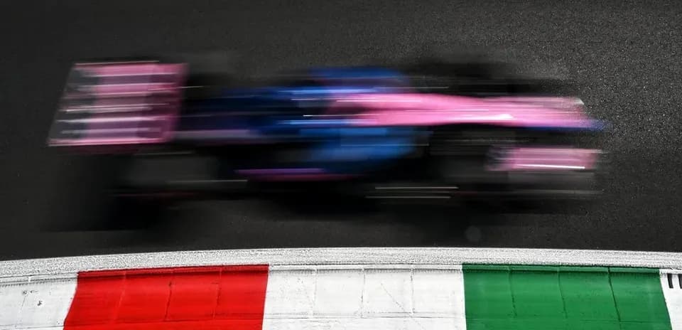 Formula 1 car speeding past track curbing