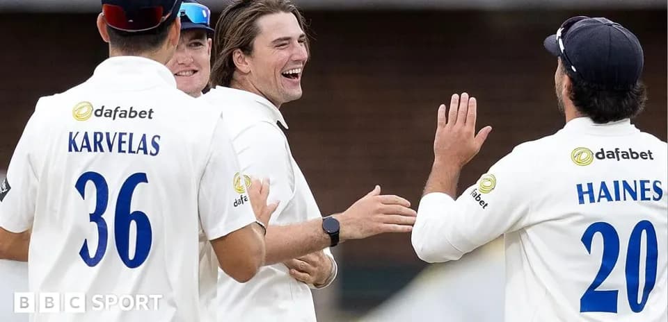 Cricket players celebrating a wicket on field