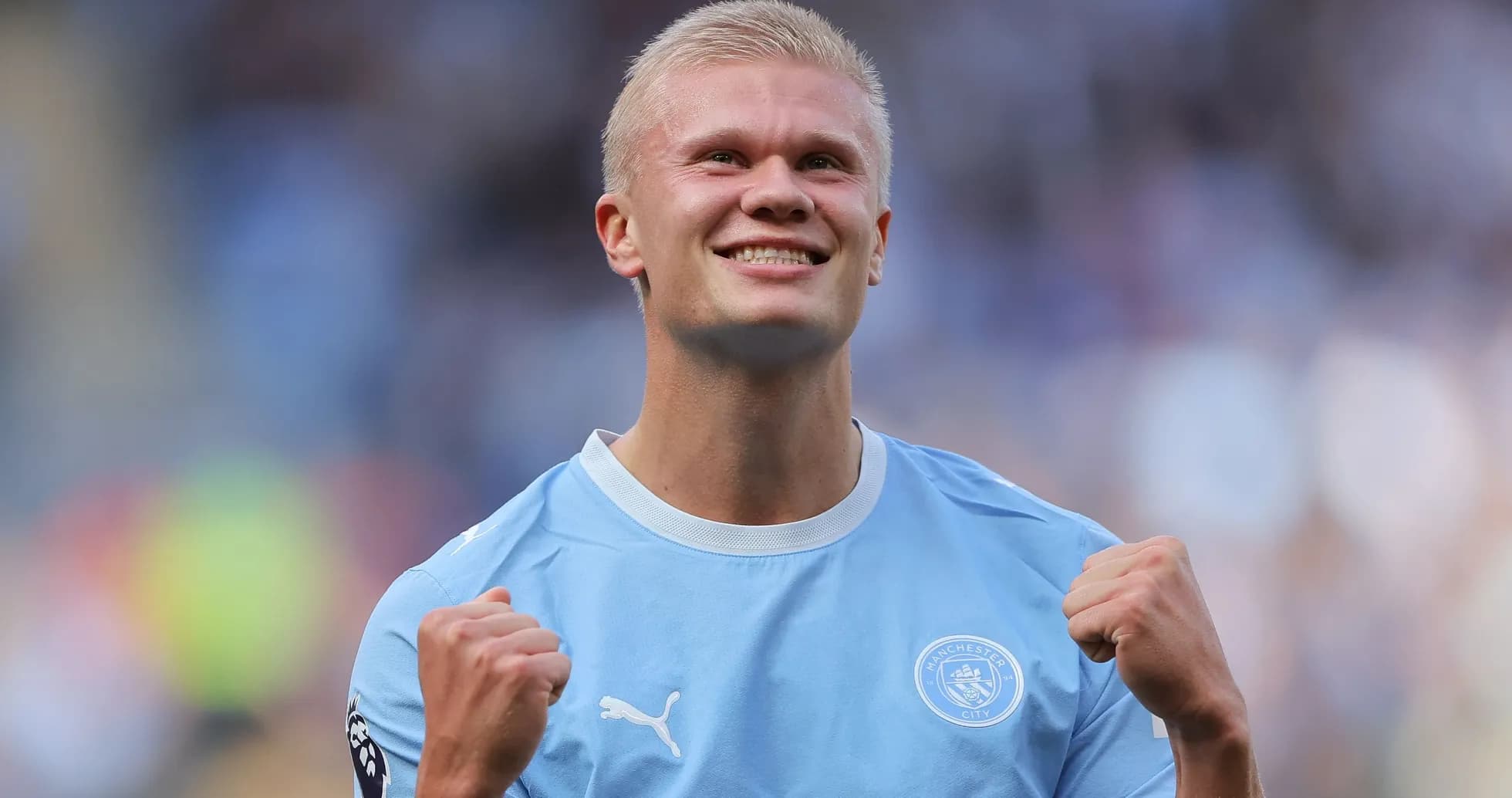 Player celebrating in Manchester City jersey on field