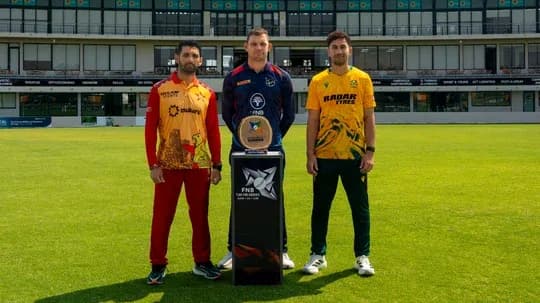 Captains posing with trophy on cricket field