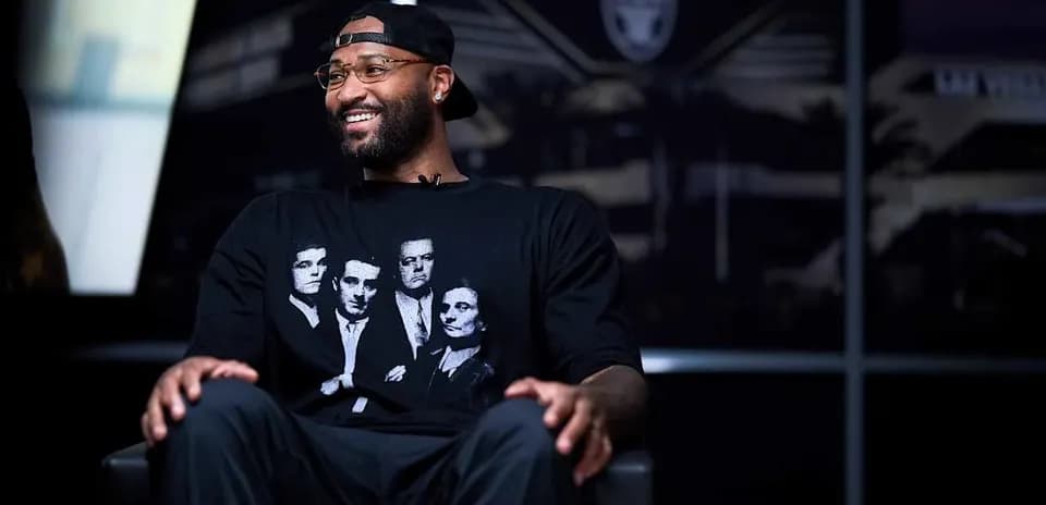 Player sitting in studio with team logo backdrop