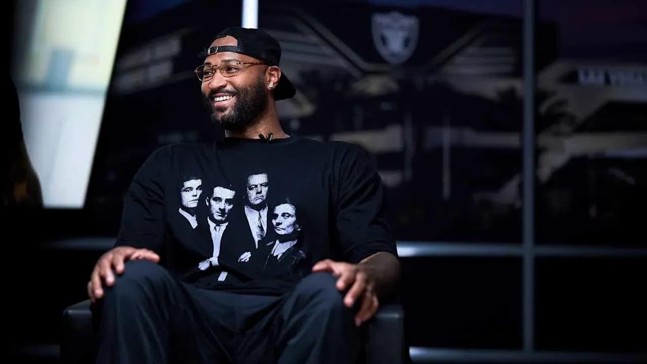 Player sitting in studio with team logo backdrop