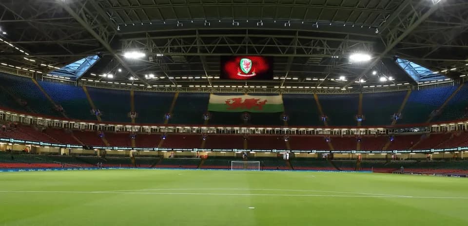 Empty stadium with Welsh flag and pitch view