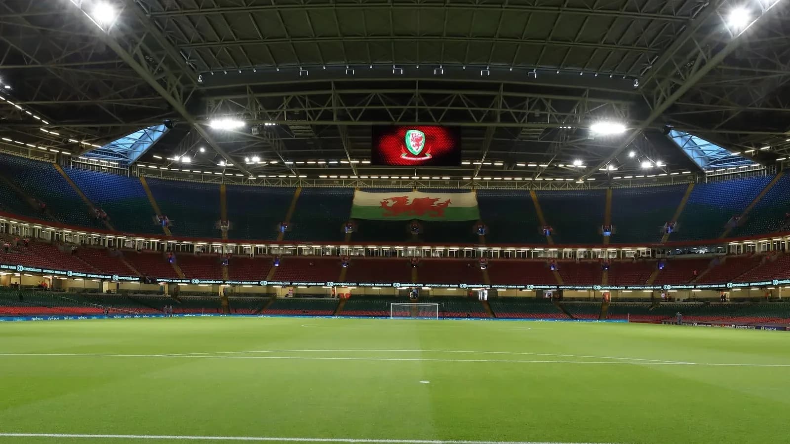 Empty stadium with Welsh flag and pitch view