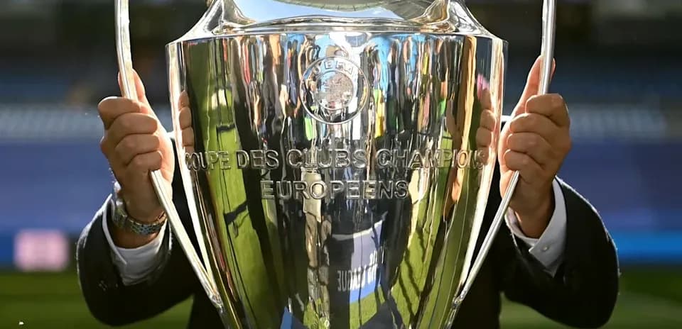 Person holding UEFA Champions League trophy