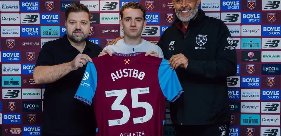Player holding jersey during signing announcement event