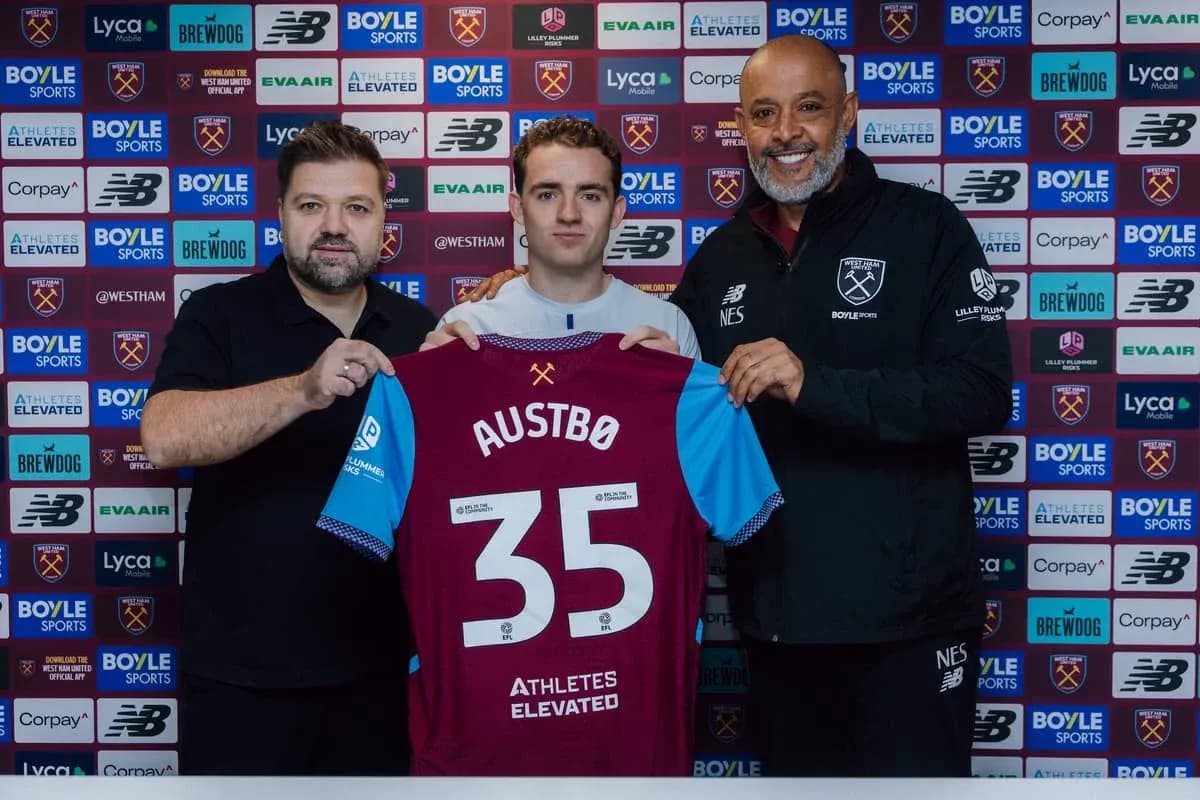 Player holding jersey during signing announcement event