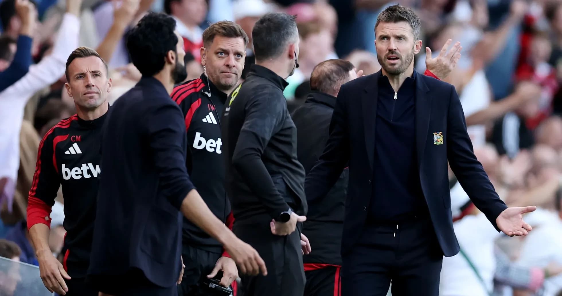 Coaching staff reacting during a tense match situation