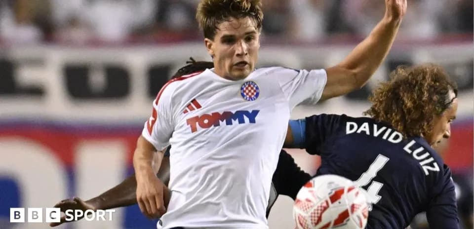 Player in white jersey challenged by opponent