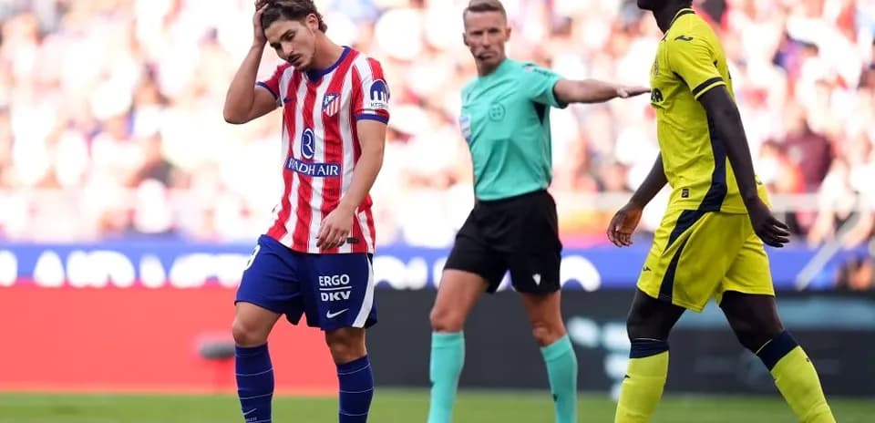 Atletico Madrid player reacts after referee's decision