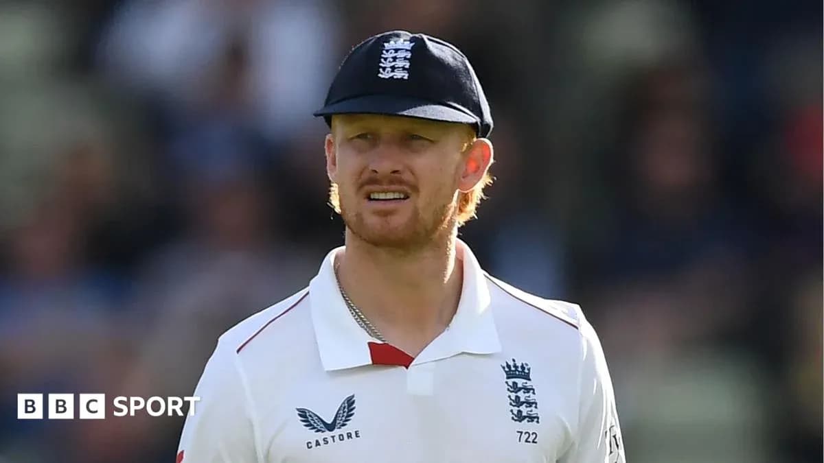 Cricketer wearing England kit and cap on field