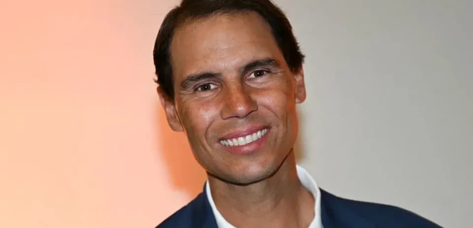 Smiling man in a suit against a light background