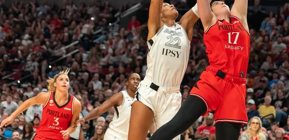 Players contesting a rebound during basketball game