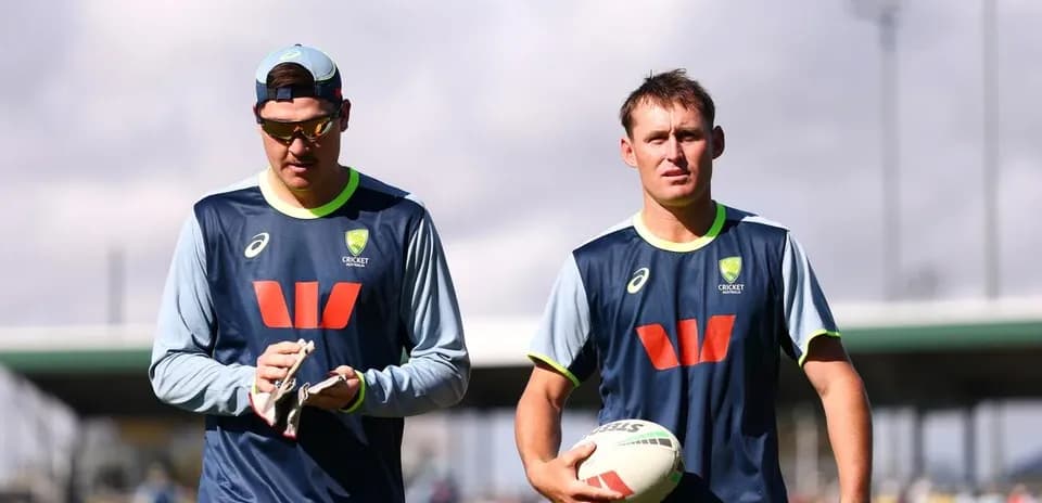 Two cricketers walking during training session