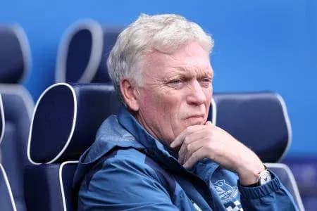 Manager deep in thought on bench during match