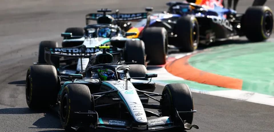 Three Formula 1 cars racing on a track