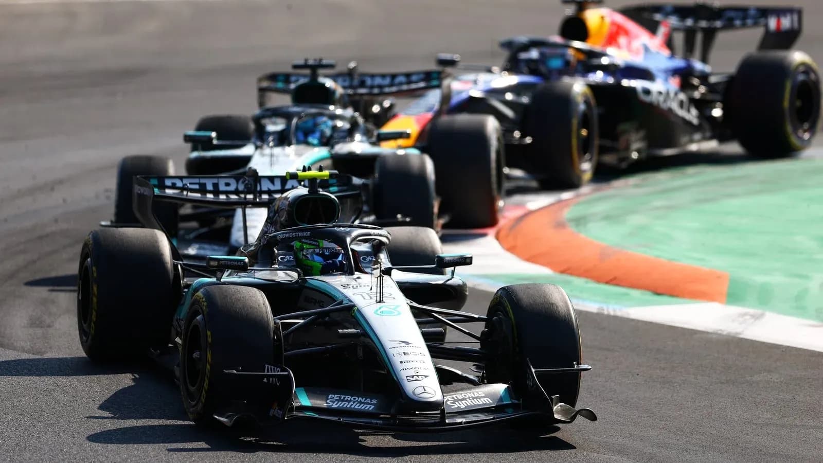 Three Formula 1 cars racing on a track