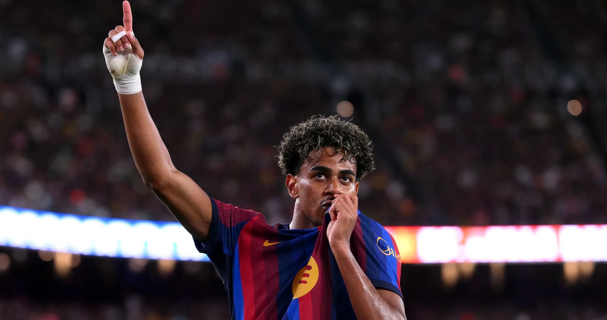 Player celebrating by lifting shirt and pointing