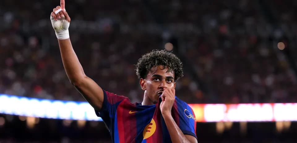 Player celebrating by lifting shirt and pointing