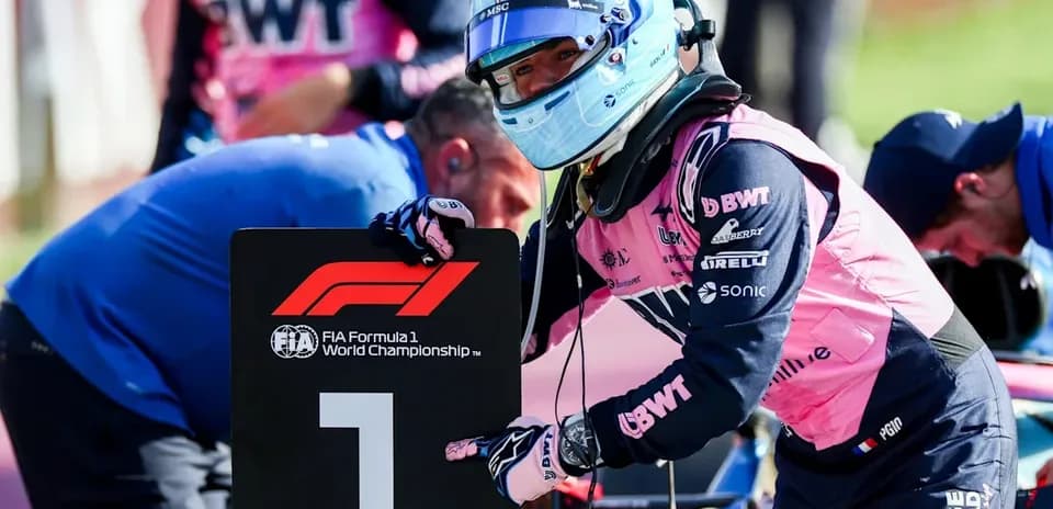 Driver holding number one sign in pit area