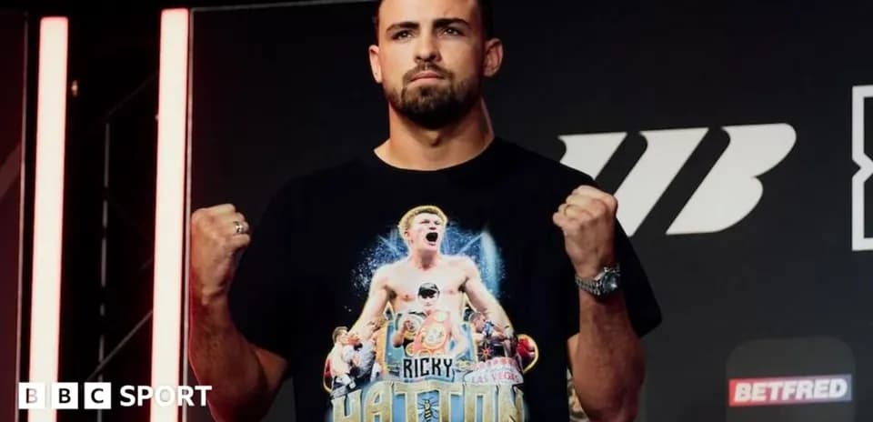 Boxer posing with clenched fists at press event