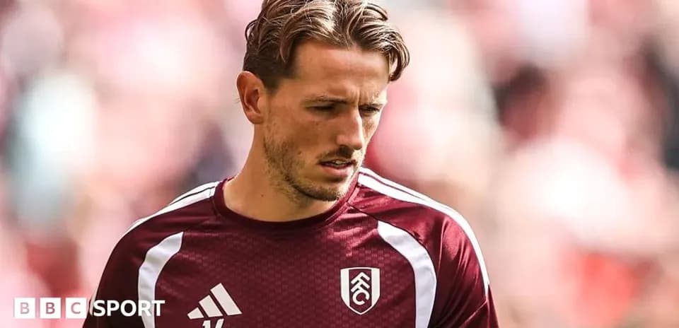 Player in Fulham training kit during warm-up