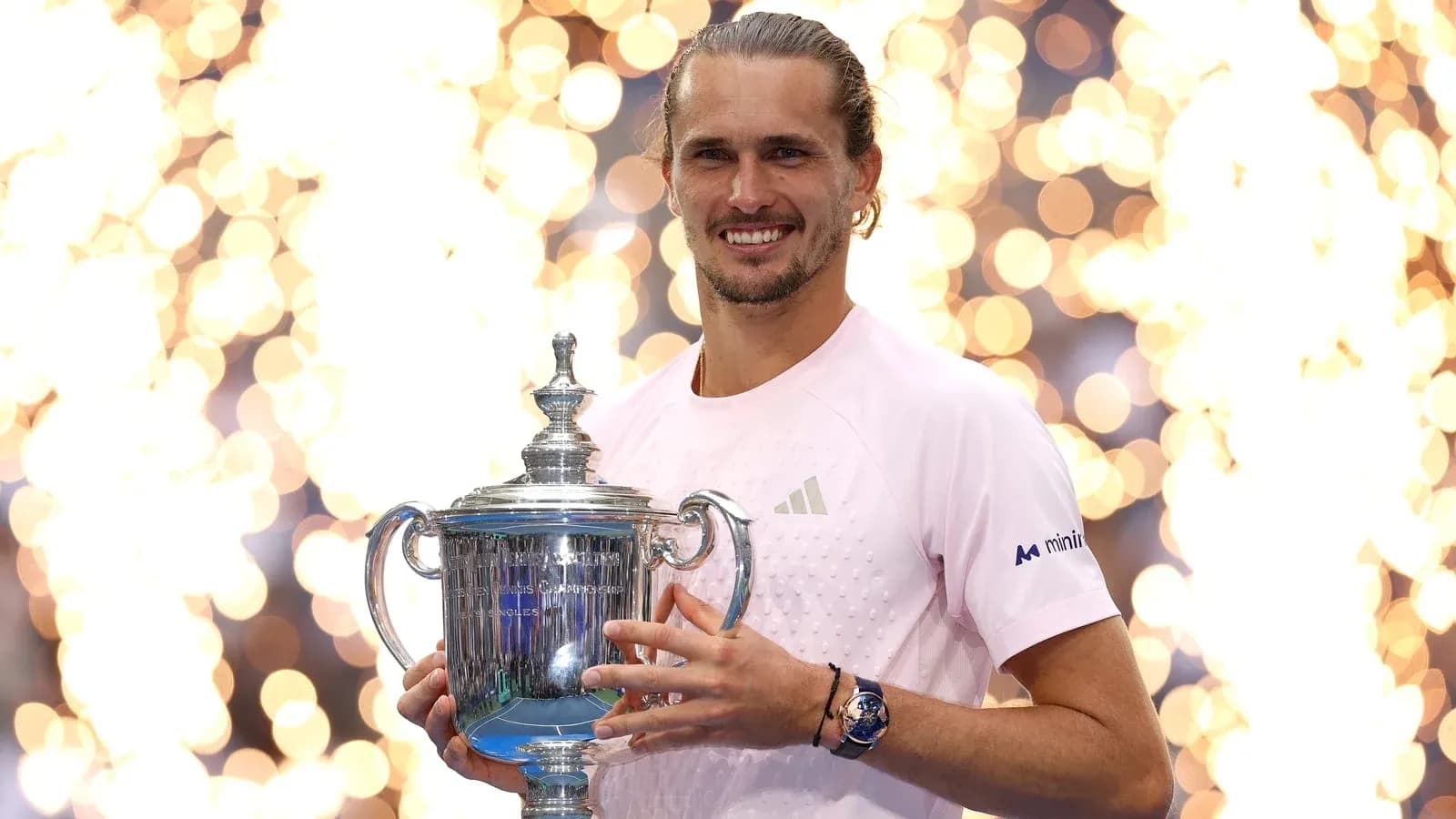 Player holding championship trophy with fireworks backdrop